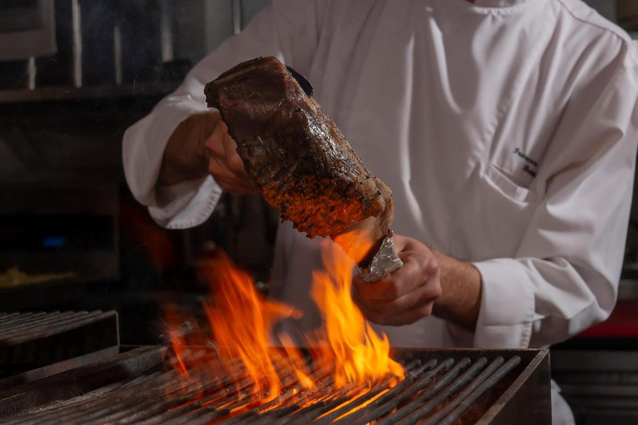The Landmark Бангкок Экстерьер фото A chef searing a steak